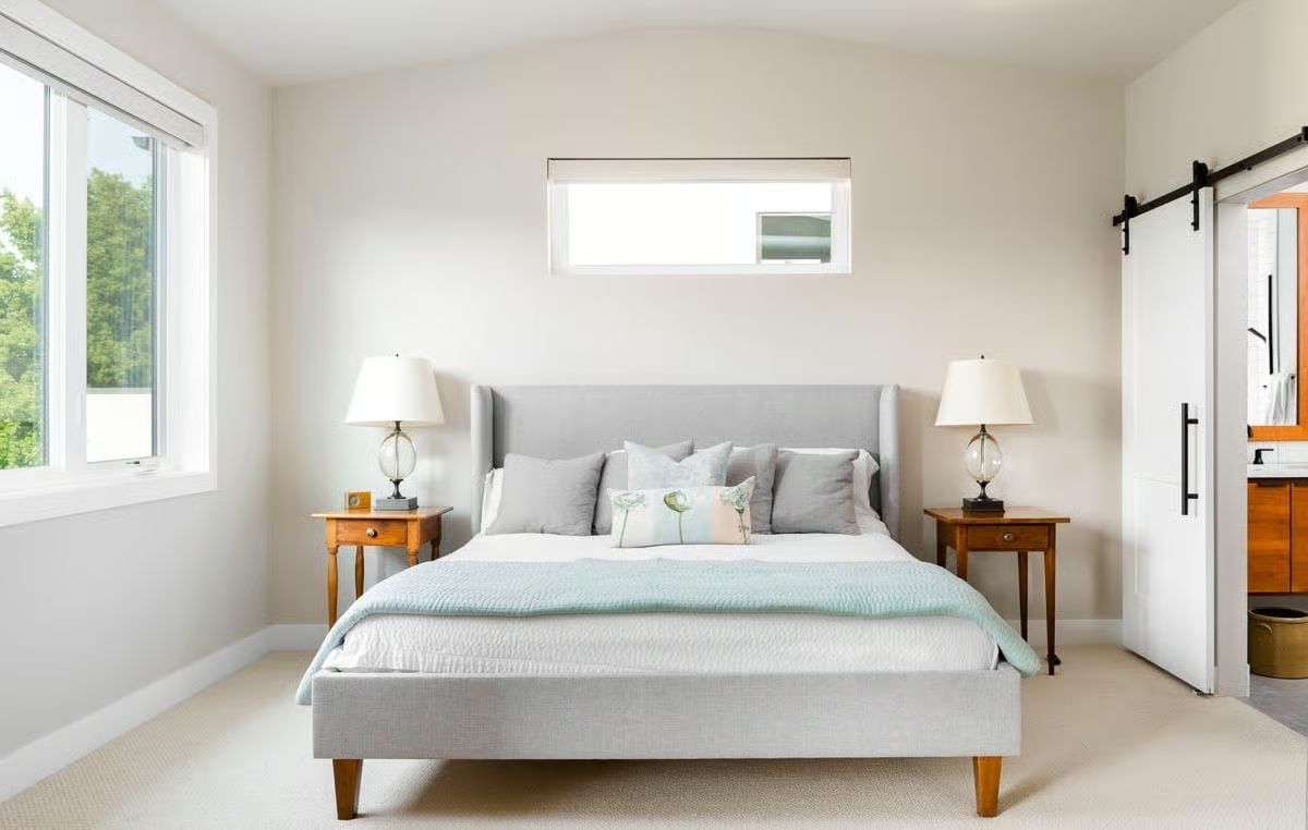 Gray Upholstered Bed, Barn Door, and the Calm That Comes From Committing to One Palette