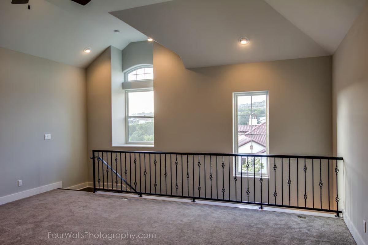 Iron Baluster Railing on an Open Loft Overlooking Neighbor Rooftops