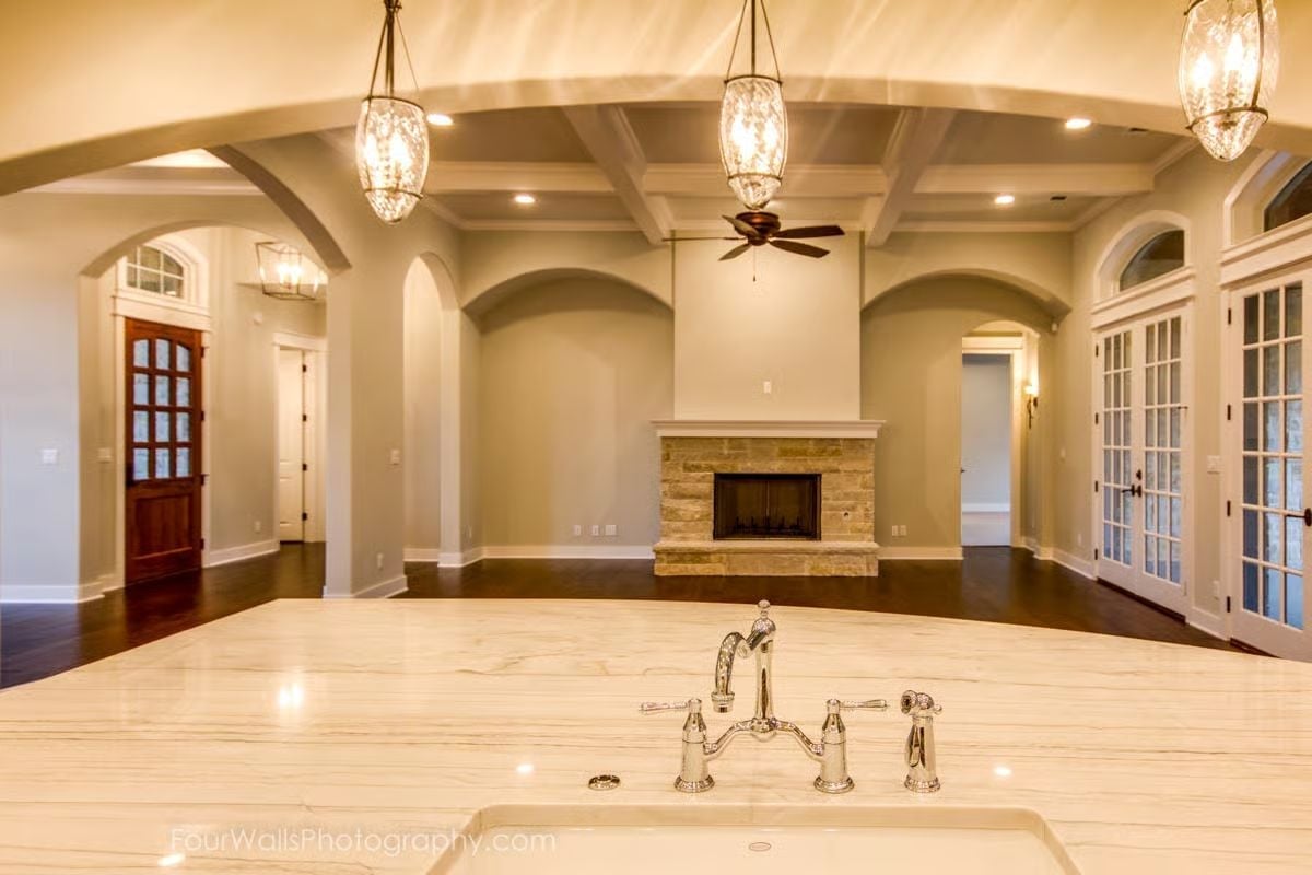 Marble Island with a Bridge Faucet and a Living Room That Earns Its Keep Beyond It