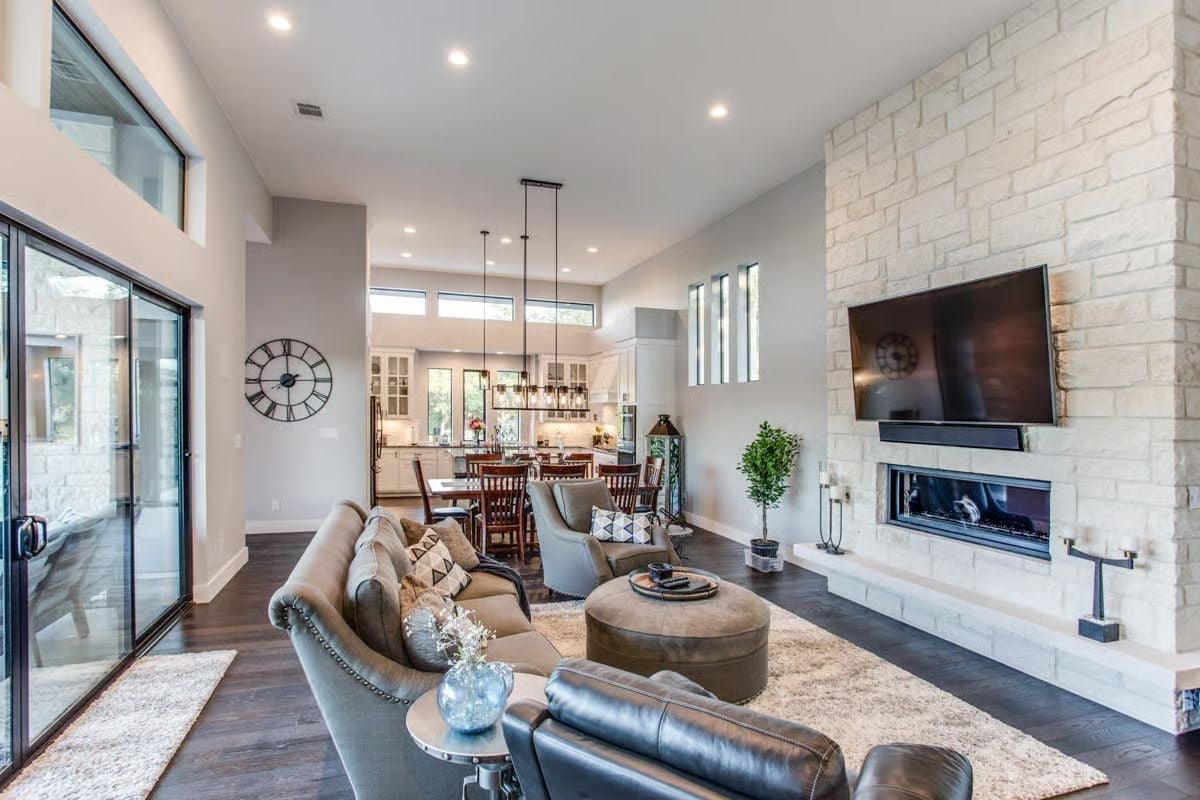Floor-to-Ceiling Stone Fireplace Commands the Open Living Space