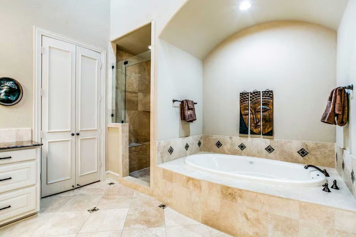 Buddha Panel Art and a Soaking Tub Tucked Under Its Own Arch