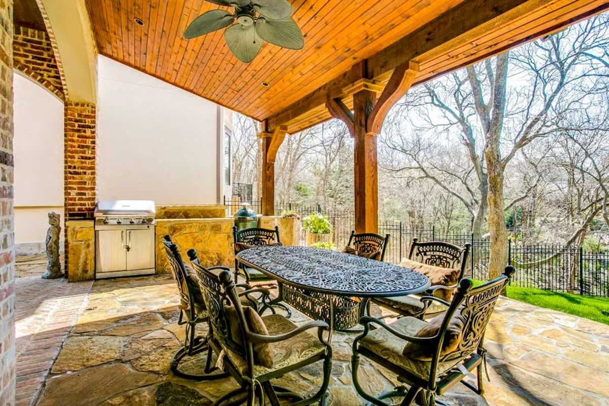 Outdoor Kitchen Built Under Timber Beams Where the Fan Actually Gets Used
