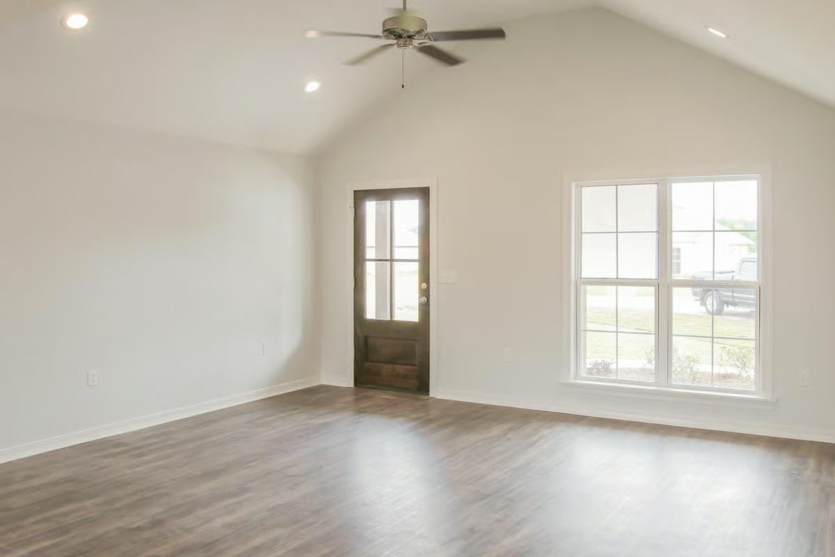 Vaulted Ceilings and Dark Wood Floors Make an Empty Room Feel Ready