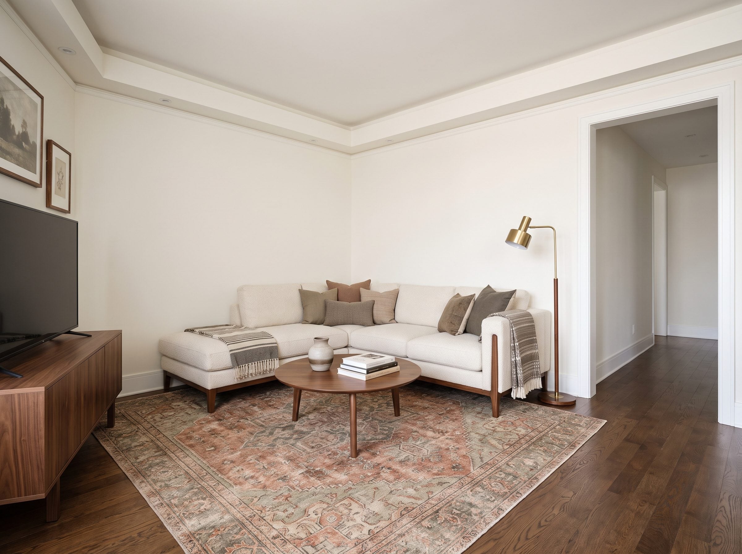 Small living room with an L-shaped sectional tucked into the corner where two walls meet and a 36-inch walkway running