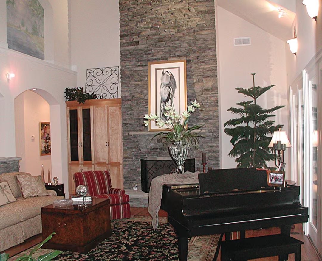 Floor-to-Ceiling Stone Fireplace That Makes a Grand Piano Feel Right at Home