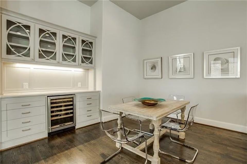 Built-In Wine Fridge and Glass-Front Cabinetry Give This Dining Nook Real Utility