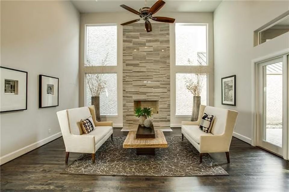 Floor-to-Ceiling Stone Fireplace Anchors a Living Room Built Around Light
