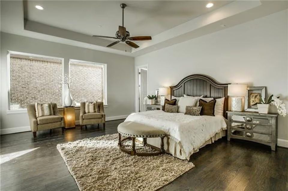 Tray Ceiling and Shag Rug Ground a Primary Bedroom That Layers Texture Without Noise
