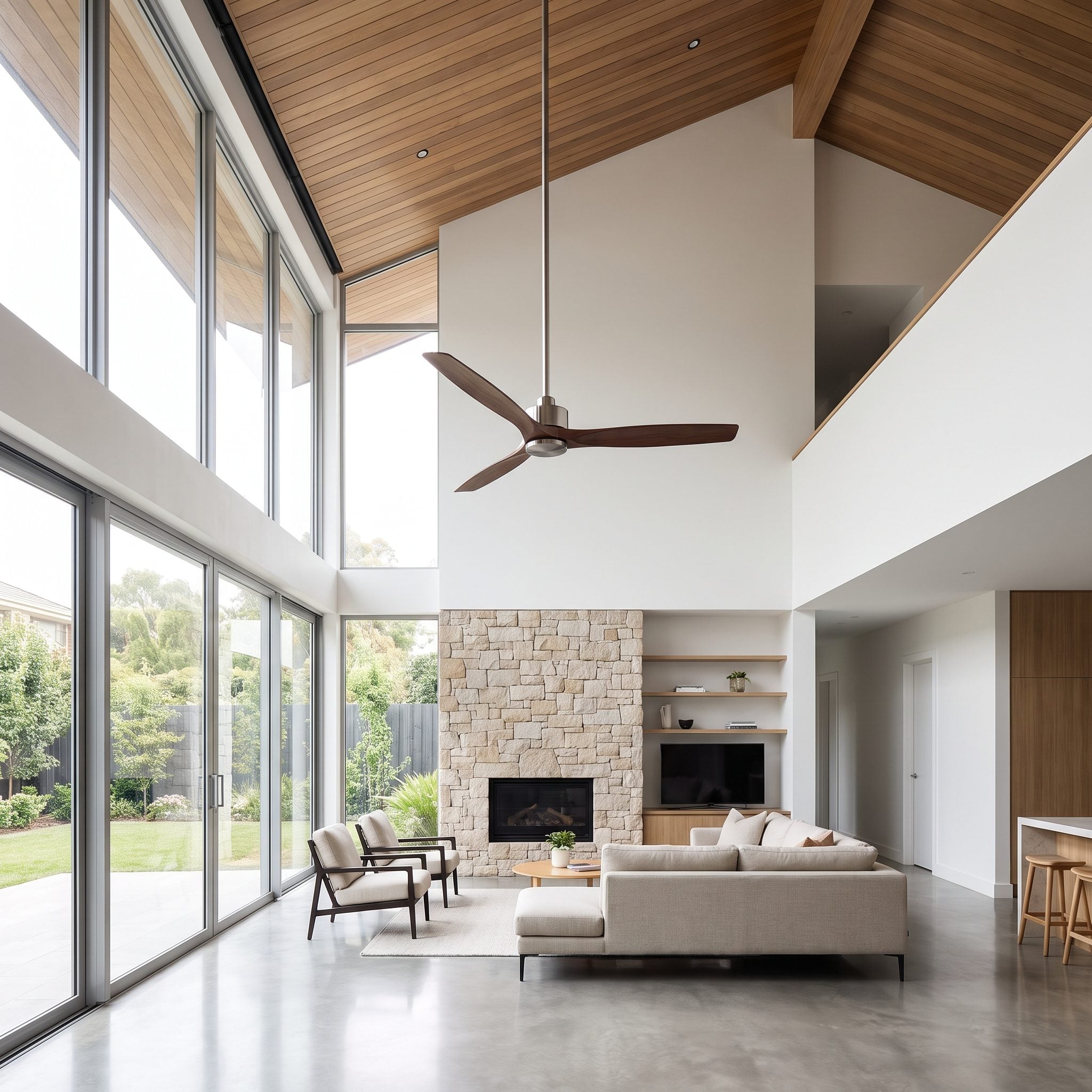 Double-height living room with a 56-inch fan on a long downrod hanging about nine feet above the floor over an 84-inch sofa.
