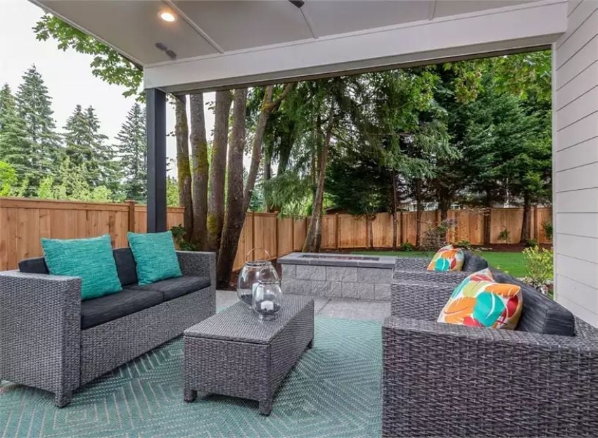 Covered Patio Where the Fire Pit Pulls You Past the Furniture