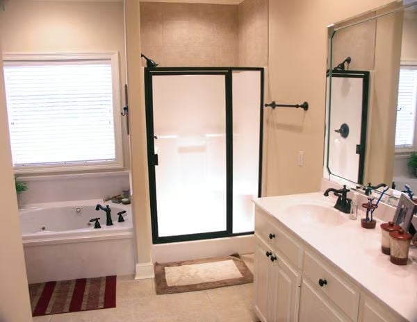 Bronze Fixtures, Glass Enclosure, and a Soaking Tub That Earns Its Corner