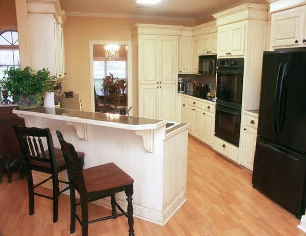 Corbeled Island, Black Appliances, and Cabinetry That Earns Its Keep