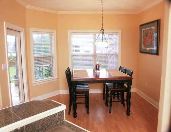 Peach Walls, Pendant Light, and Placemat-Ready Table for Four