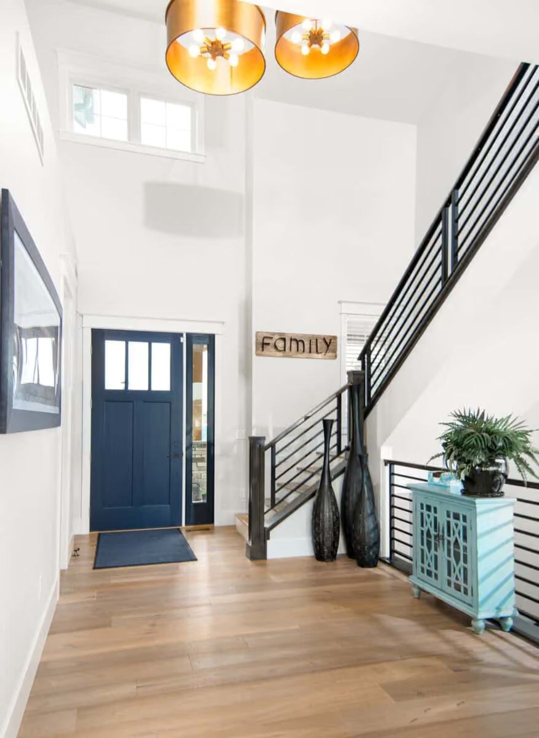 Gold-Drum Pendants and a Navy Door Set the Tone Before You Take a Step