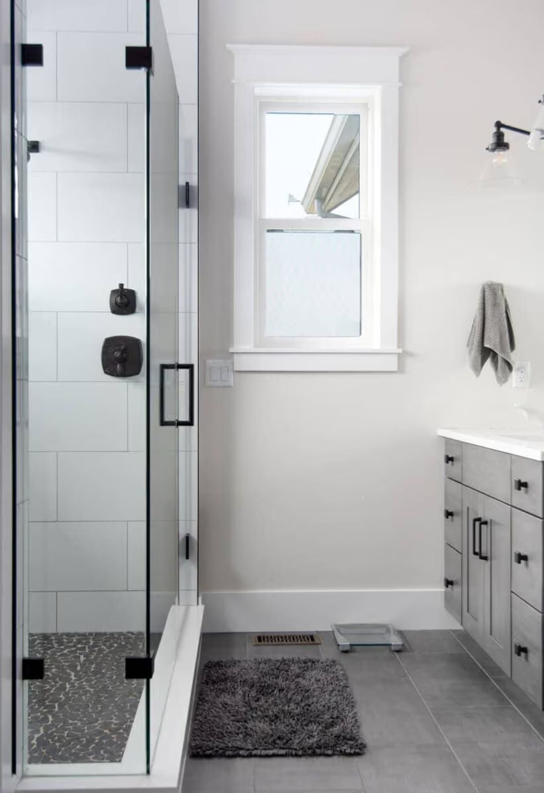 Matte Black Hardware Ties the Shower and Vanity Into One Cohesive Statement