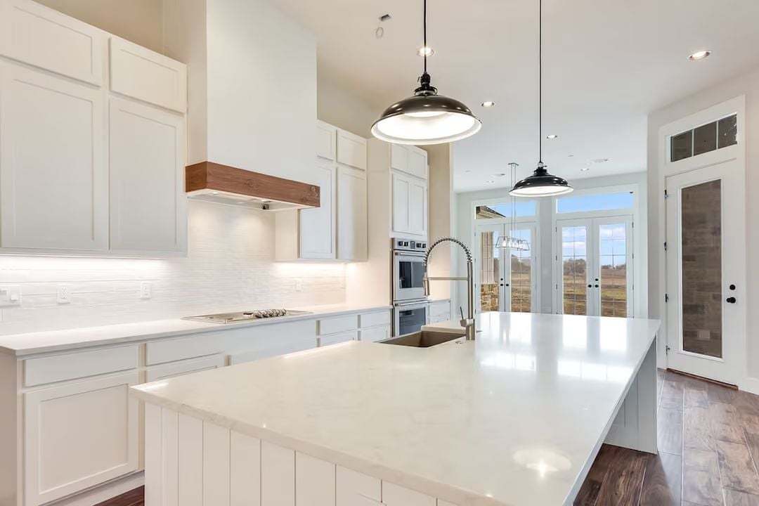 Quartz Island and Wood Range Hood Pull This Kitchen in Two Directions at Once