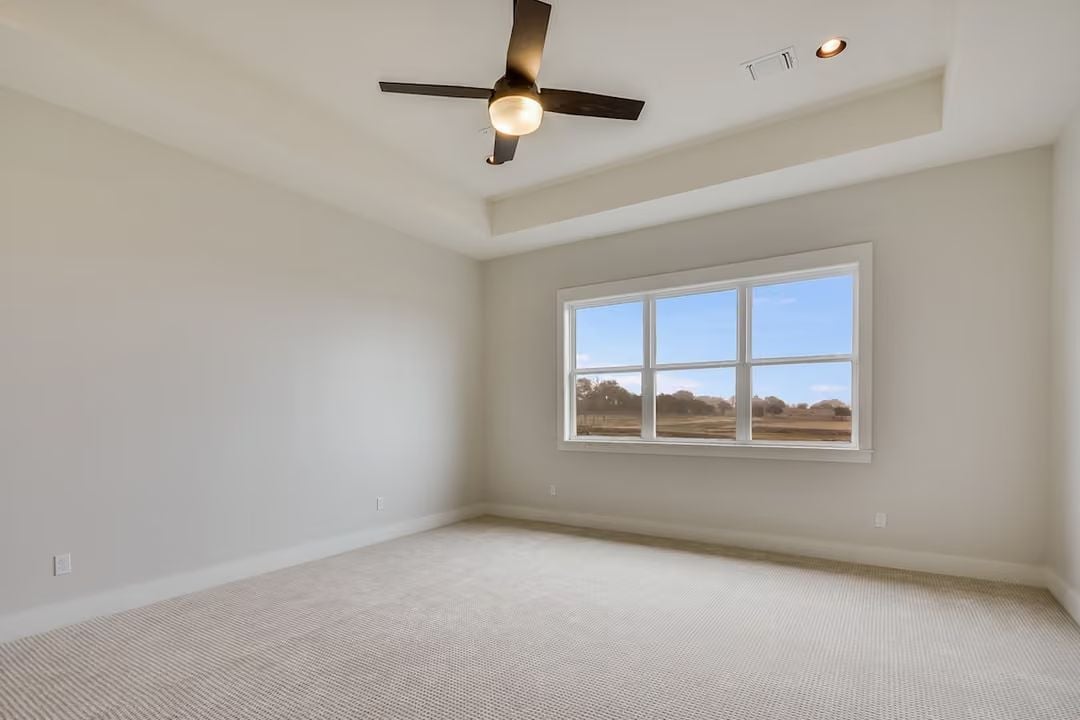 Tray Ceiling and Open Carpet Make This Bedroom Feel Larger Than It Is