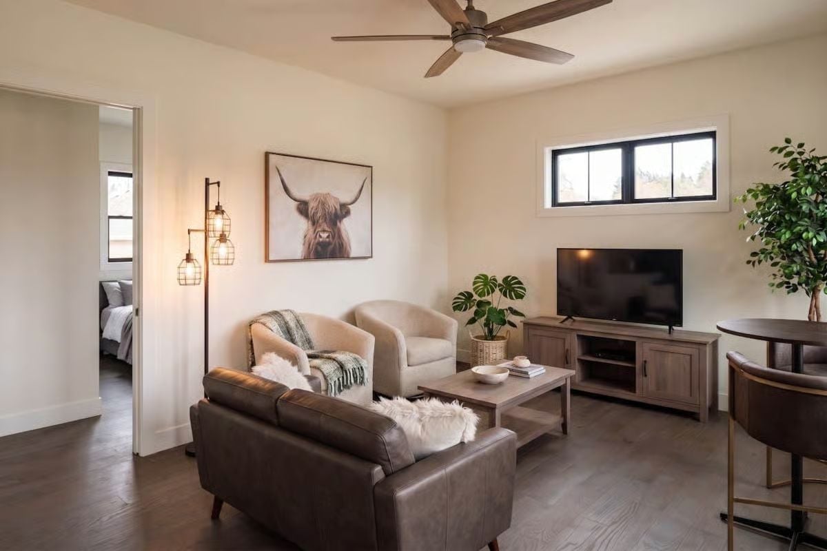 Highland Cow Art and a Leather Sofa Walk Into a Living Room