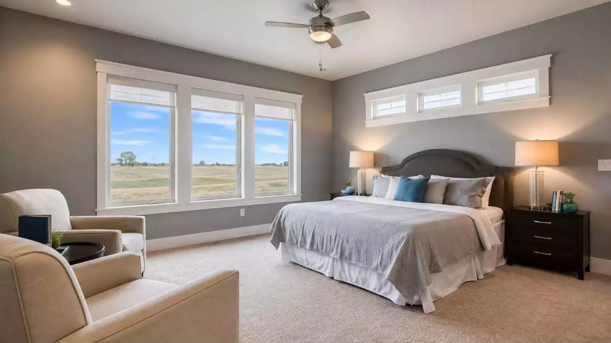 Gray Walls and a Prairie View Make This Master Bedroom Feel Twice Its Size