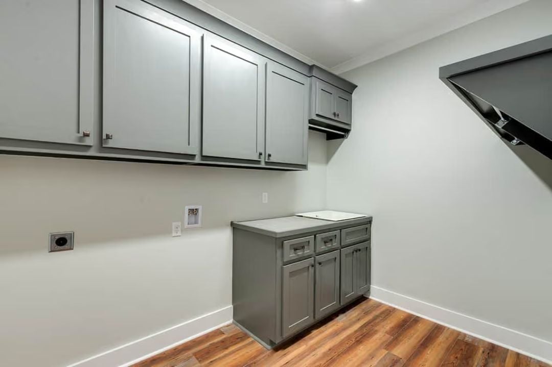 Gray Cabinetry and a Folding Counter Built for Laundry That Actually Piles Up