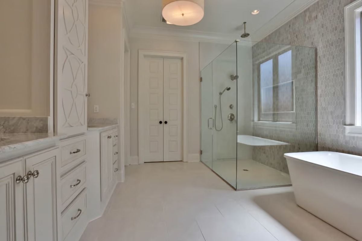 Frameless Glass and Mosaic Stone Make the Shower the Clear Focal Point