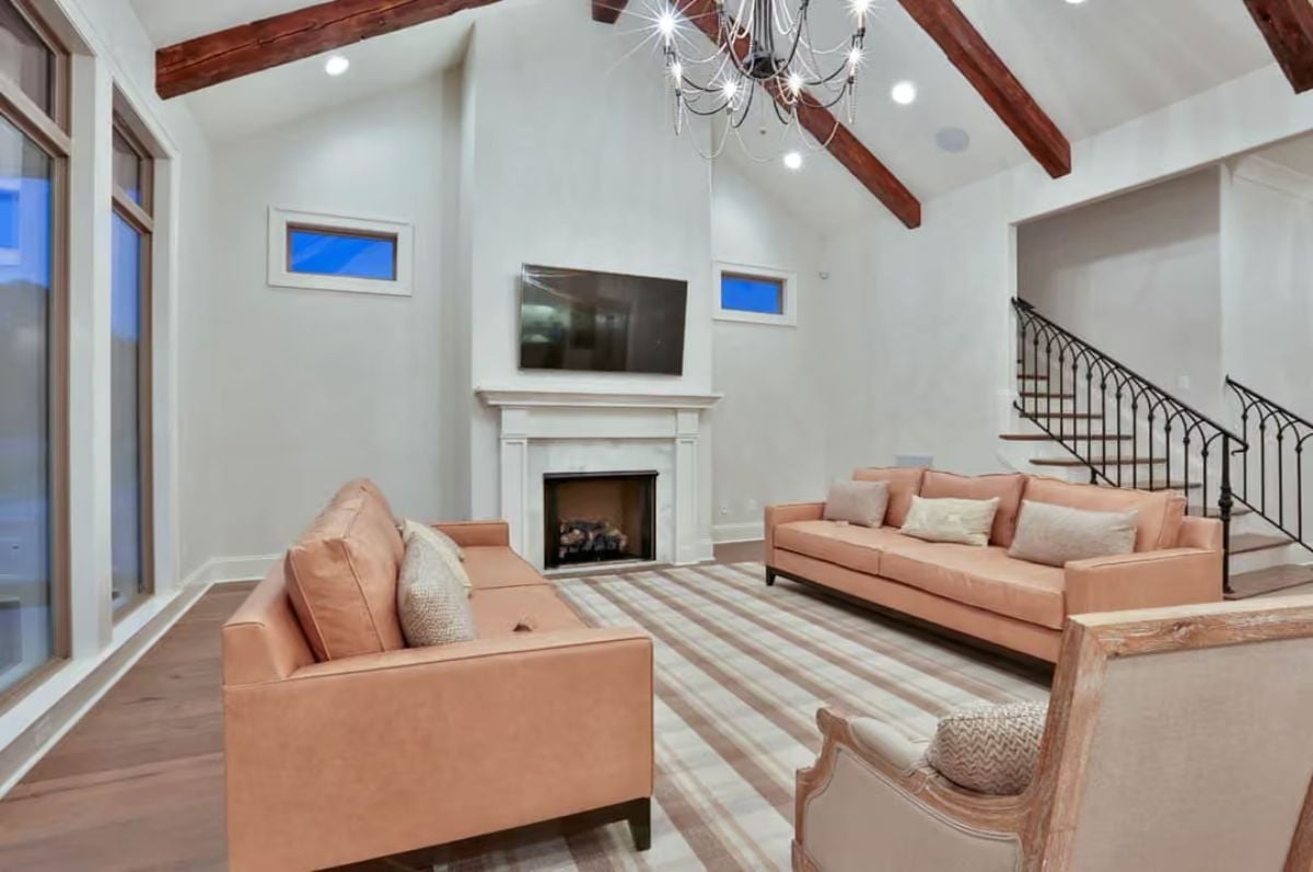 Salmon Leather Sofas and a White Marble Fireplace Are a Pairing Worth Studying