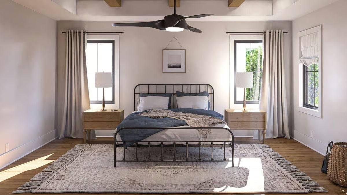 Black Iron Bed Frame, Blue Bedding, and a Ceiling Fan That Means Business