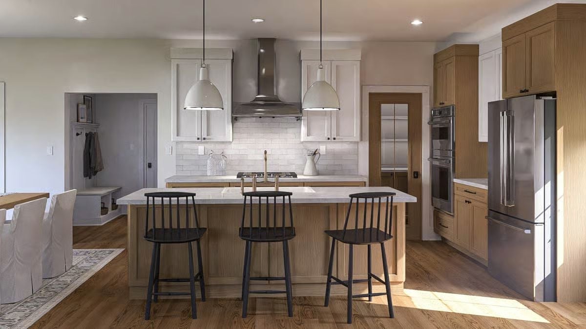 Brass Faucet, Black Barstools, and a Kitchen Island That's Doing a Lot of Heavy Lifting