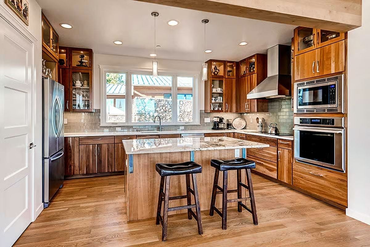 Granite Island, Two Stools, and a Range Hood That Means Business