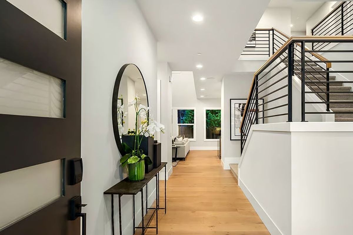 Oval Mirror, Orchids, and a Front Door That Sets the Whole Tone