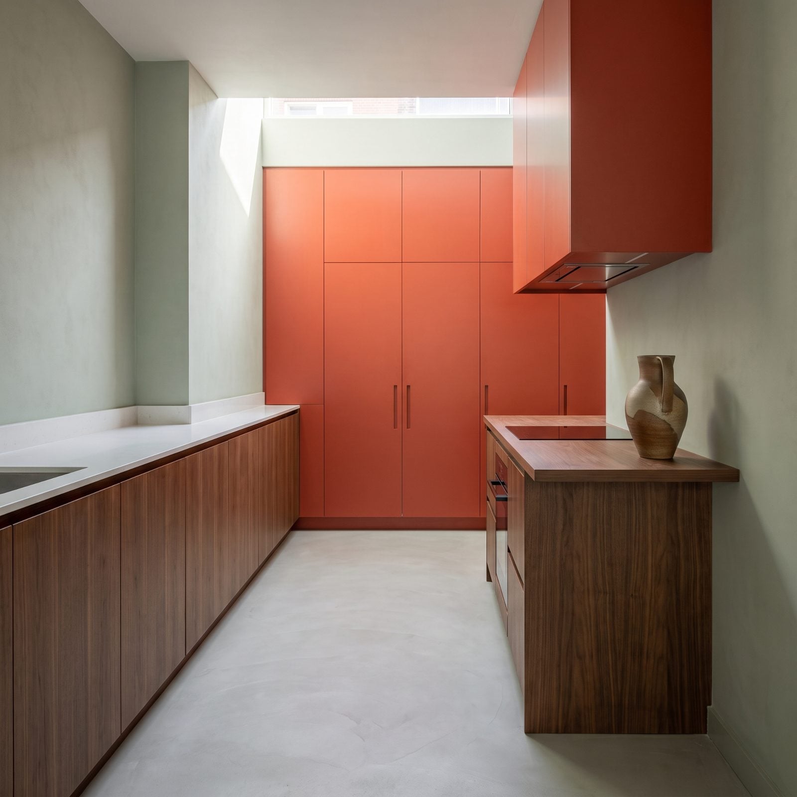 Minimal Walnut Kitchen With a Vermilion Cabinet Wall