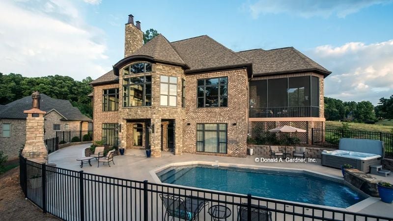 Brick, Black Iron, and a Pool That Makes the Neighbors Quietly Reconsider Their Life Choices