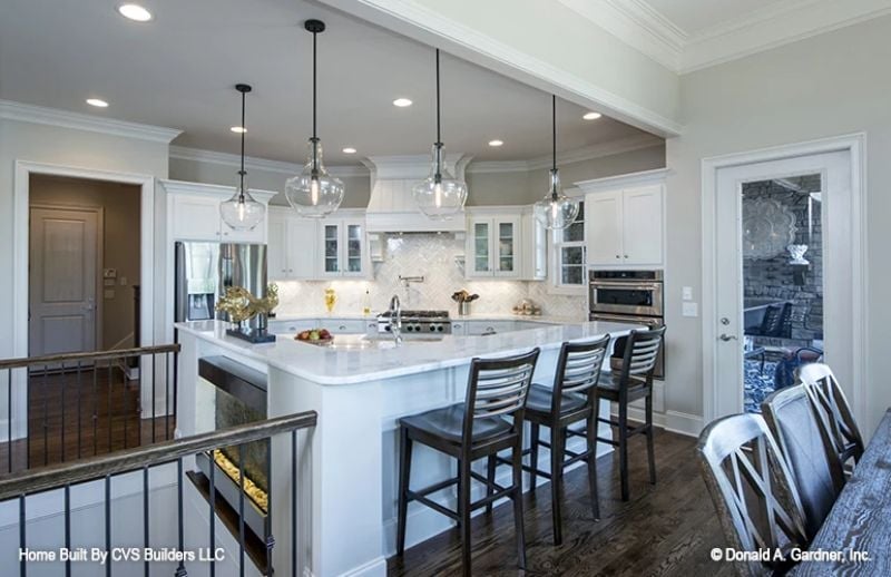 Pendant Lights Over a White Island That's Clearly Running the Whole Kitchen