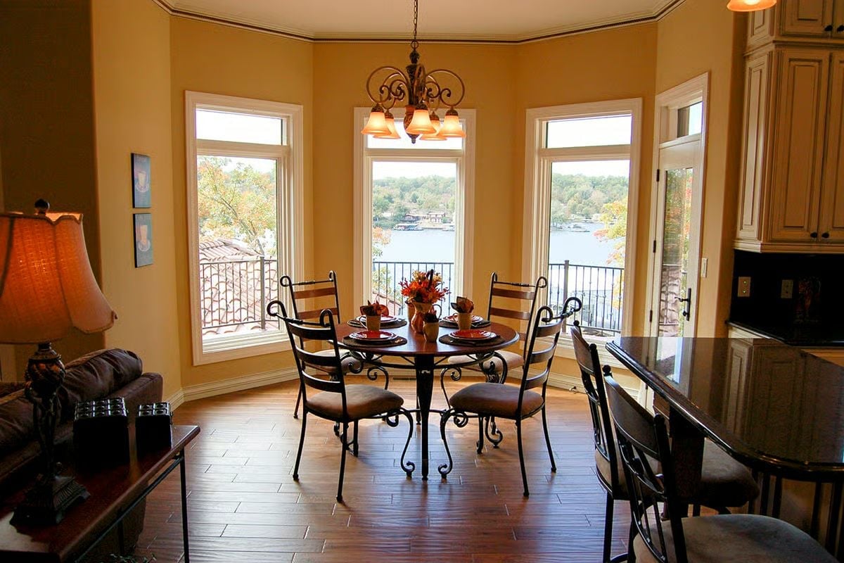 Wrought Iron Dining Set Pulled Up to a Lake View That Does the Decorating