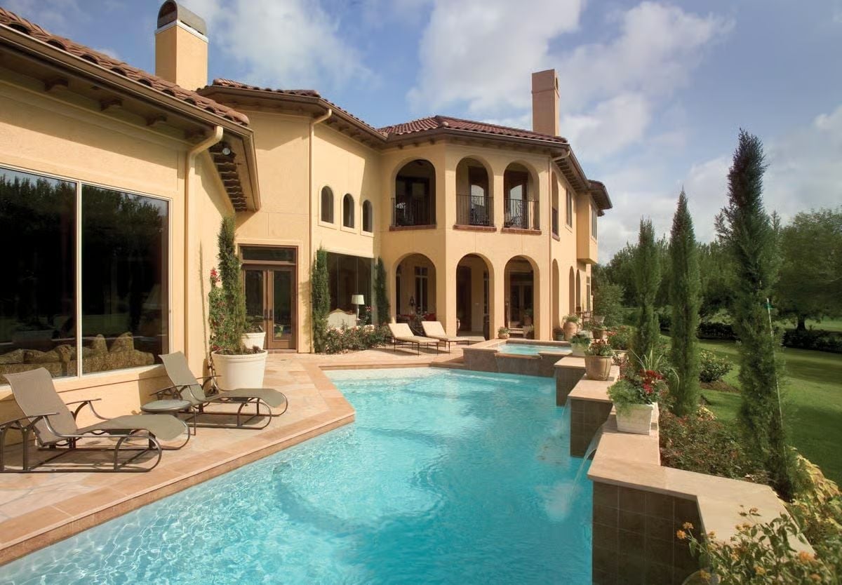 Lap Pool Framed by Cypress Trees Earns Every Square Foot of Patio Around It