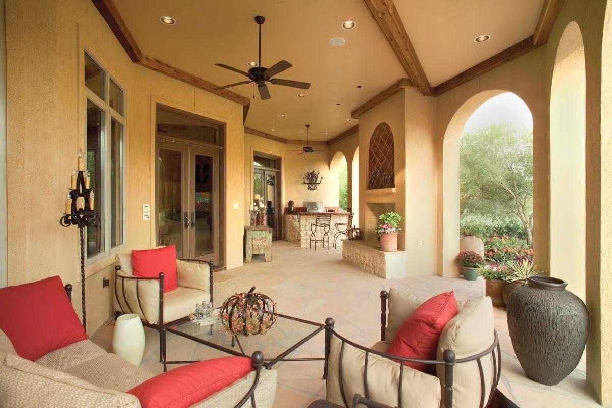 Loggia Living Where Forged Iron and Red Cushions Pull You Outside Year-Round