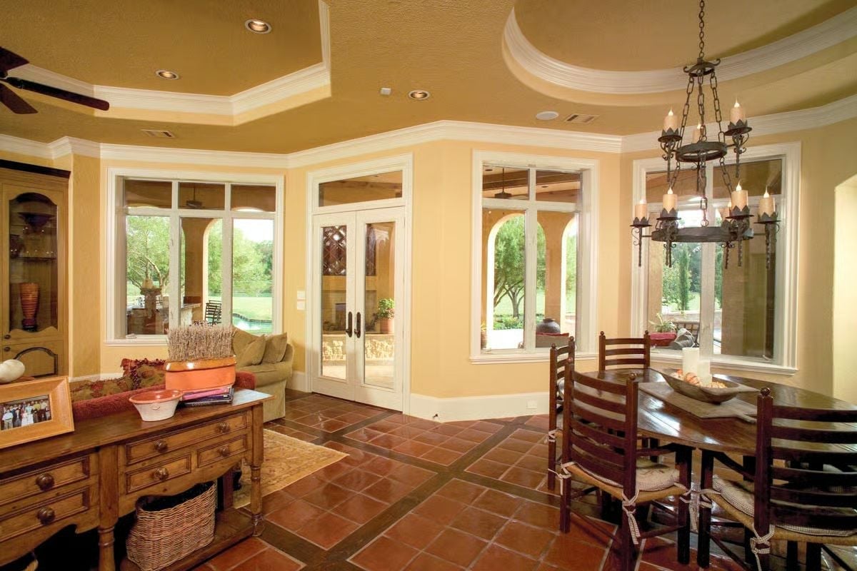 Wrought-Iron Chandelier Anchors a Dining Room Built Around Terra Cotta Floors