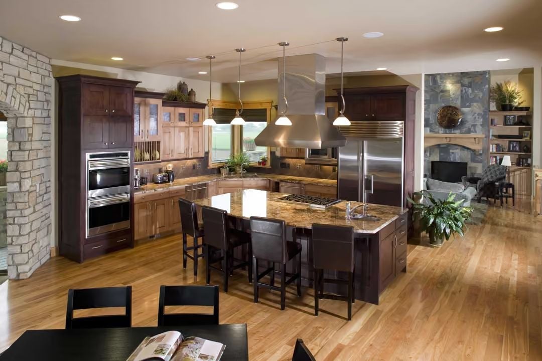 Dark Cabinetry and Granite That Actually Earn the Open-Plan Layout