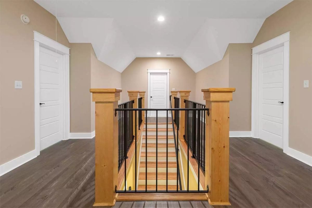 Craftsman Newel Posts and Iron Balusters on a Landing That Actually Has Room to Breathe