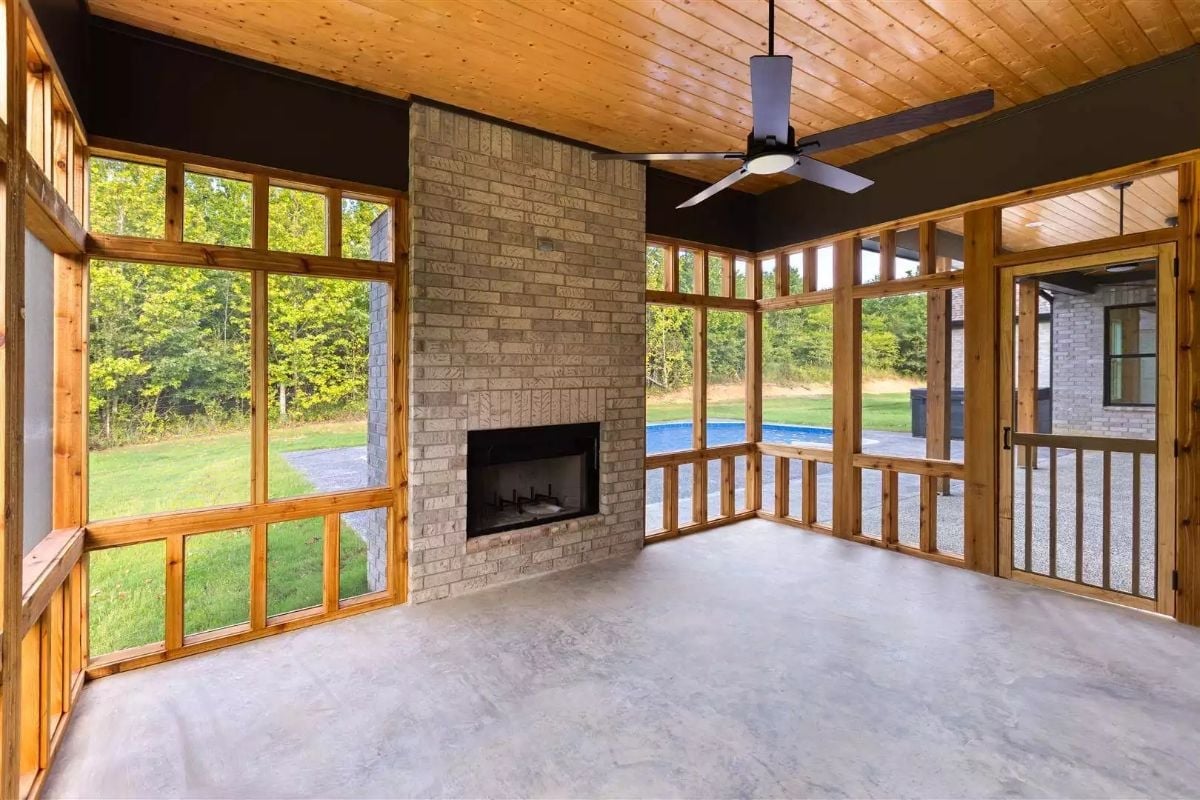 Screened Porch With a Brick Fireplace That Actually Earns Its Square Footage