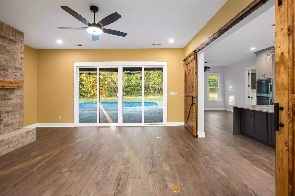 Yellow Walls, Barn Door, Brick Fireplace: Open Living Done Right