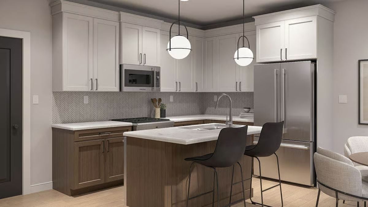 Herringbone Backsplash, Two-Tone Cabinets, and Pendant Lights That Earn Their Keep