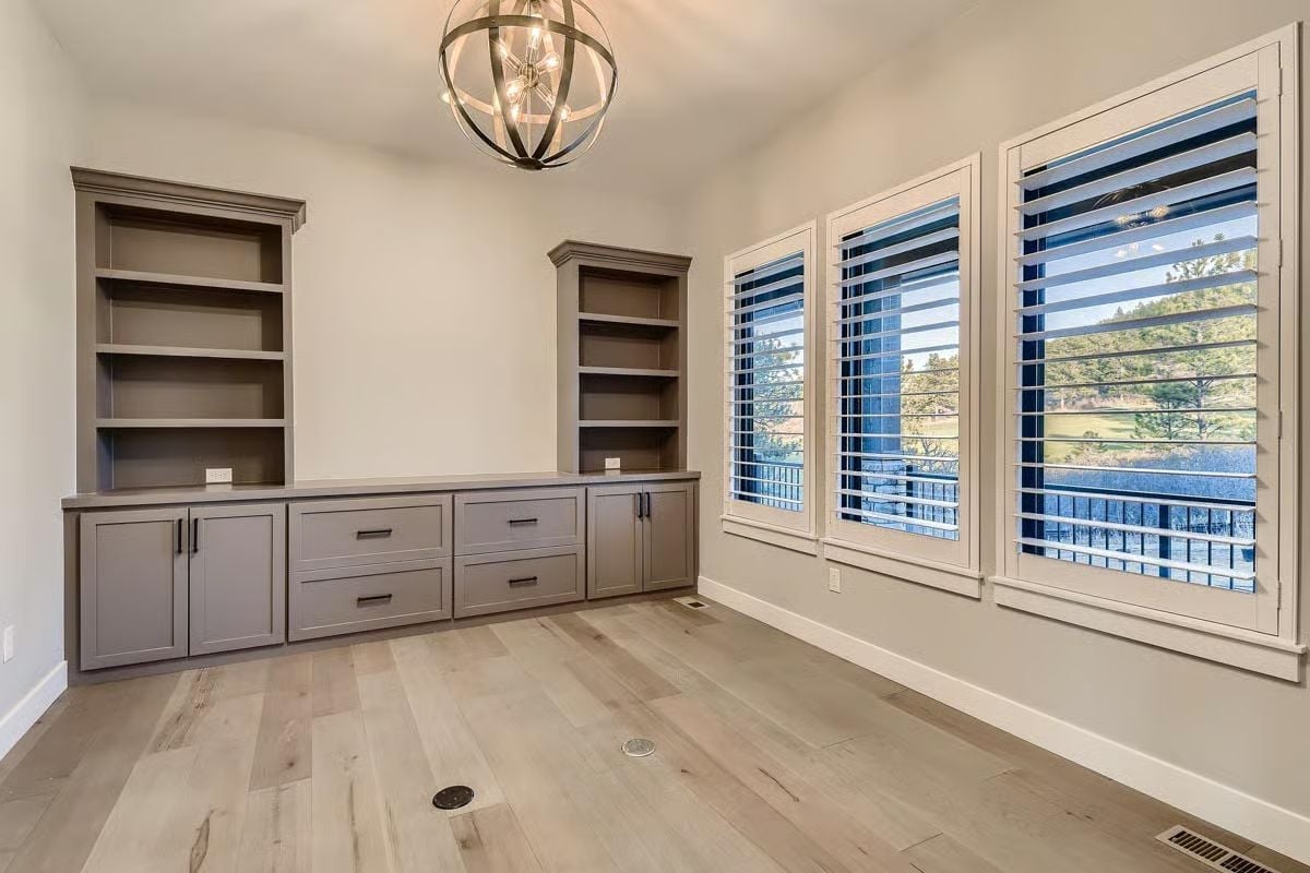 Built-In Storage Wall, Globe Chandelier, and a View Worth Orienting the Desk Toward