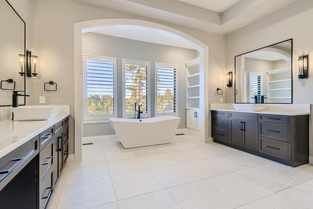 Dual Vanities, a Freestanding Tub, and an Arch That Earns Its Keep