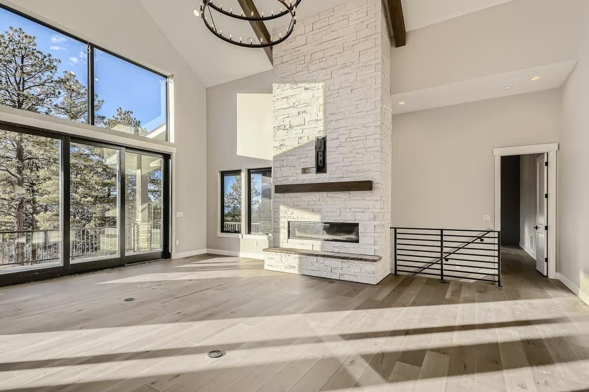 Floor-to-Ceiling Stone, a Linear Fireplace, and Views That Pull You Toward the Glass