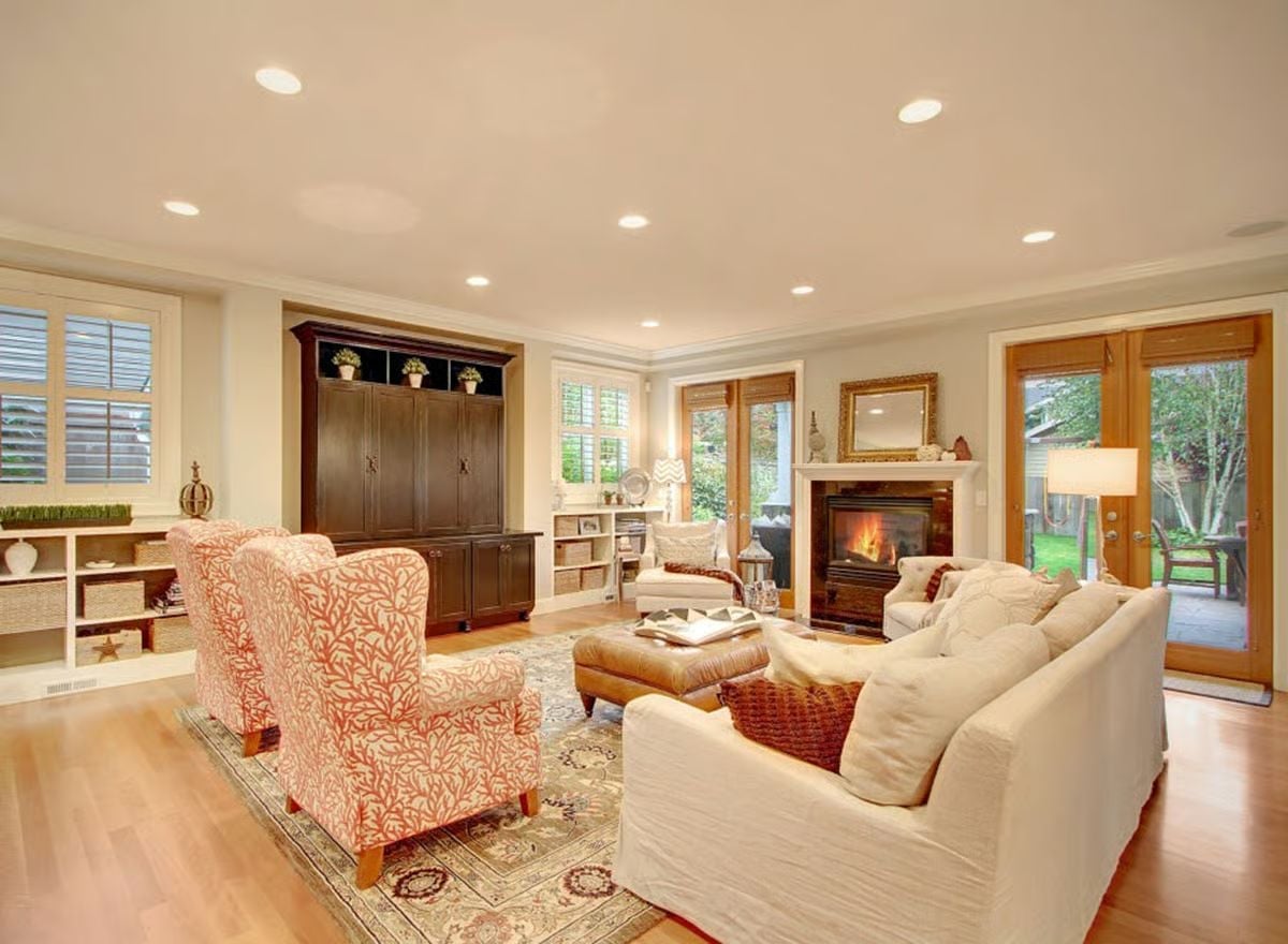Coral-Patterned Chairs Against a Lit Fireplace Make This Room Hard to Leave