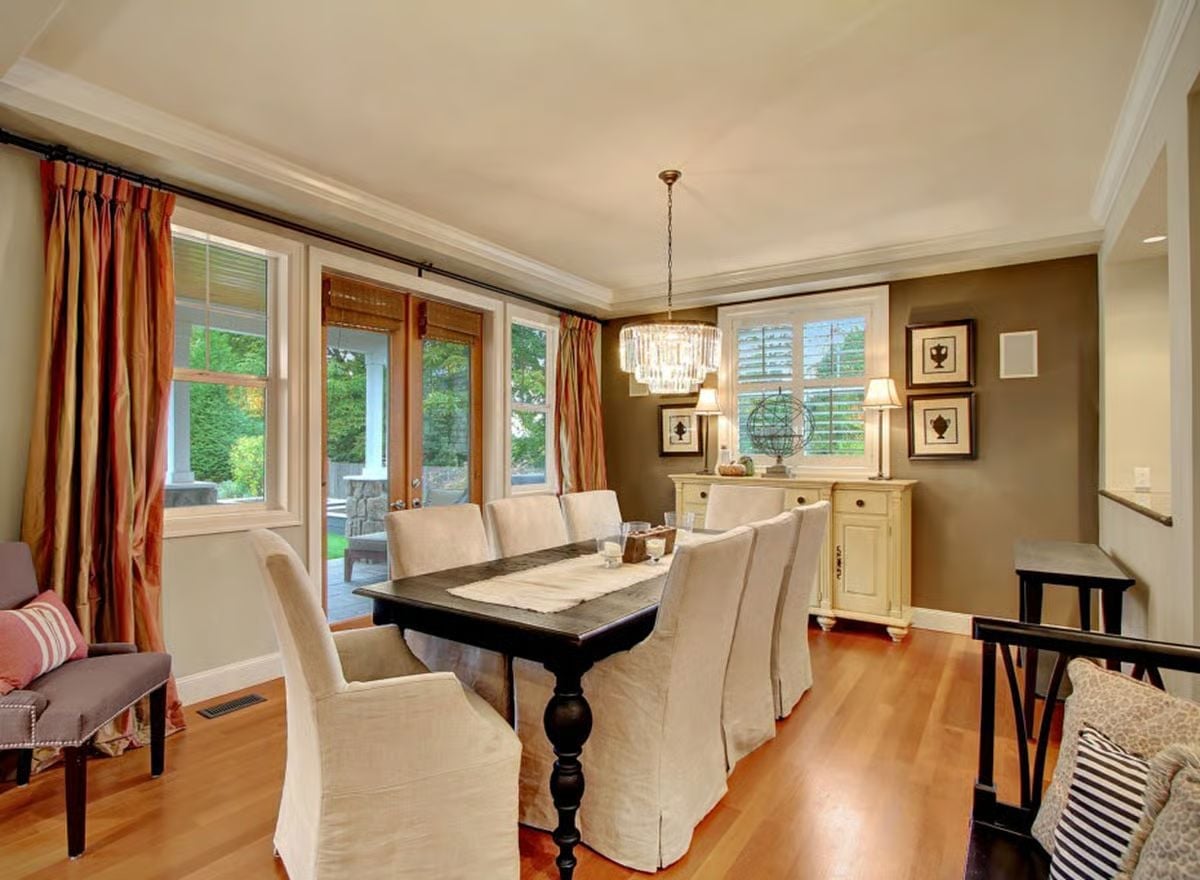 Slipcovered Chairs Around a Dark Table Pull Off Casual Elegance Without Trying