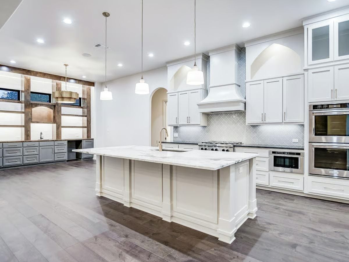 Marble Island with a Sink Faucet Positioned Like It Owns the Room
