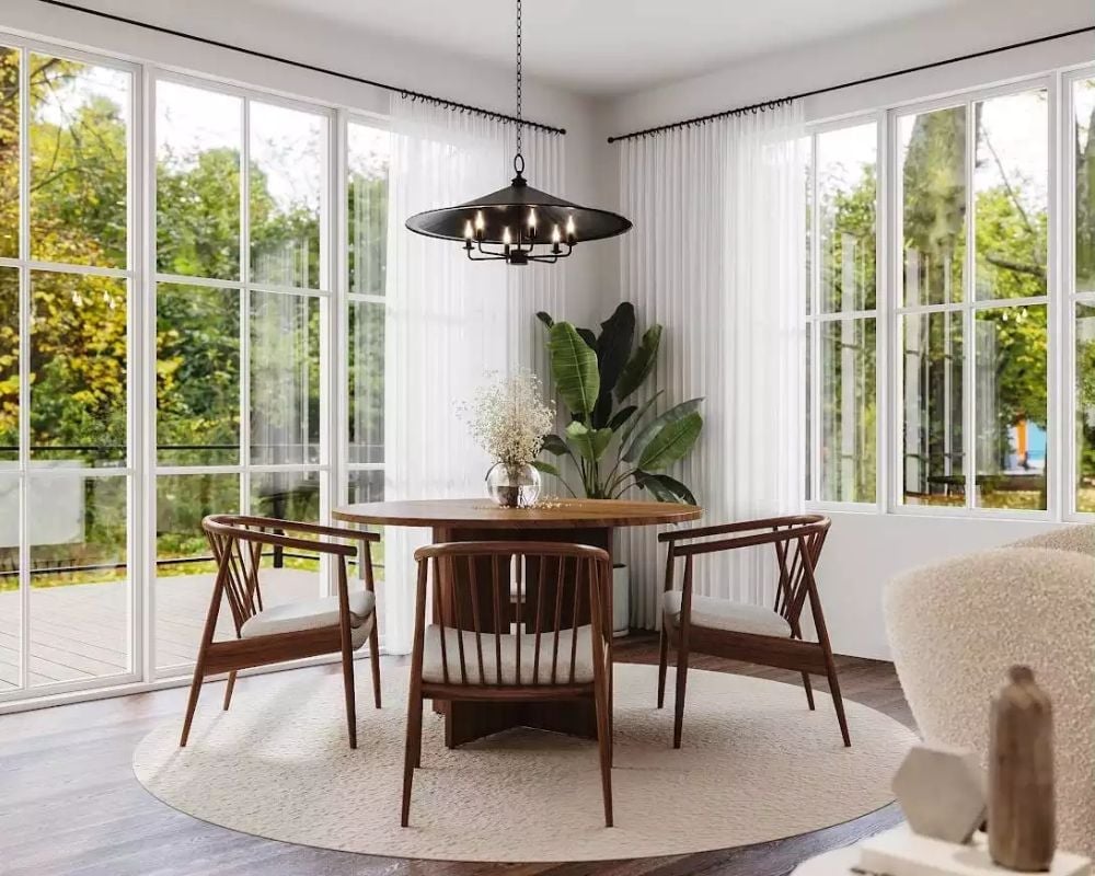Walnut Dining Set in a Glass-Wrapped Corner That Pulls the Trees Inside