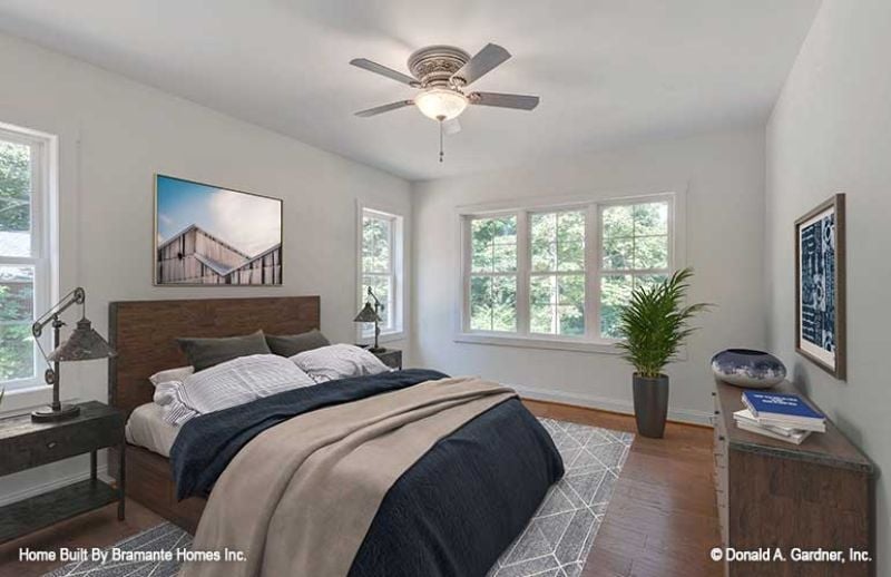Dark Wood Headboard, Navy Bedding, and Windows That Do the Heavy Lifting